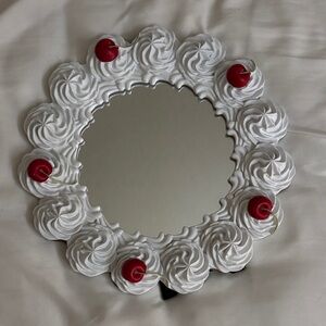 Decorative Mirror with White Swirl Design and Red Accents